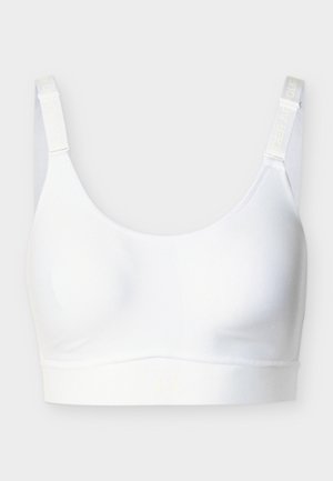 Biely bezšvový športová podprsenka s nastaviteľnými ramienkami a logom Under Armour na páse a ramienkach.
