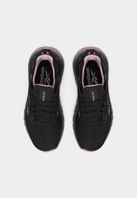 Ζευγάρι μαύρα και ροζ παπούτσια τρεξίματος Reebok, ορατά από πάνω, σε απλό λευκό φόντο.