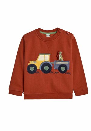 Red sweatshirt with long sleeves, featuring a yellow tractor and dinosaur applique. Button detail on shoulder, soft fabric texture.