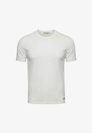 Maglietta bianca semplice a maniche corte con scollo tondo e piccolo marchio vicino all'orlo inferiore, esposta su uno sfondo semplice.