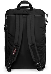 Black backpack with padded shoulder straps, a durable nylon exterior, multiple zippered compartments, and a top carrying handle.