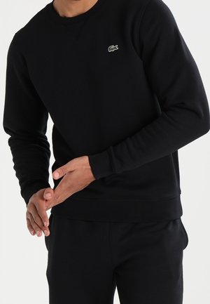 Zwarte sweatshirts van een katoenmix, met een ronde halslijn, geribbelde manchetten en een klein groen logo op de borst.