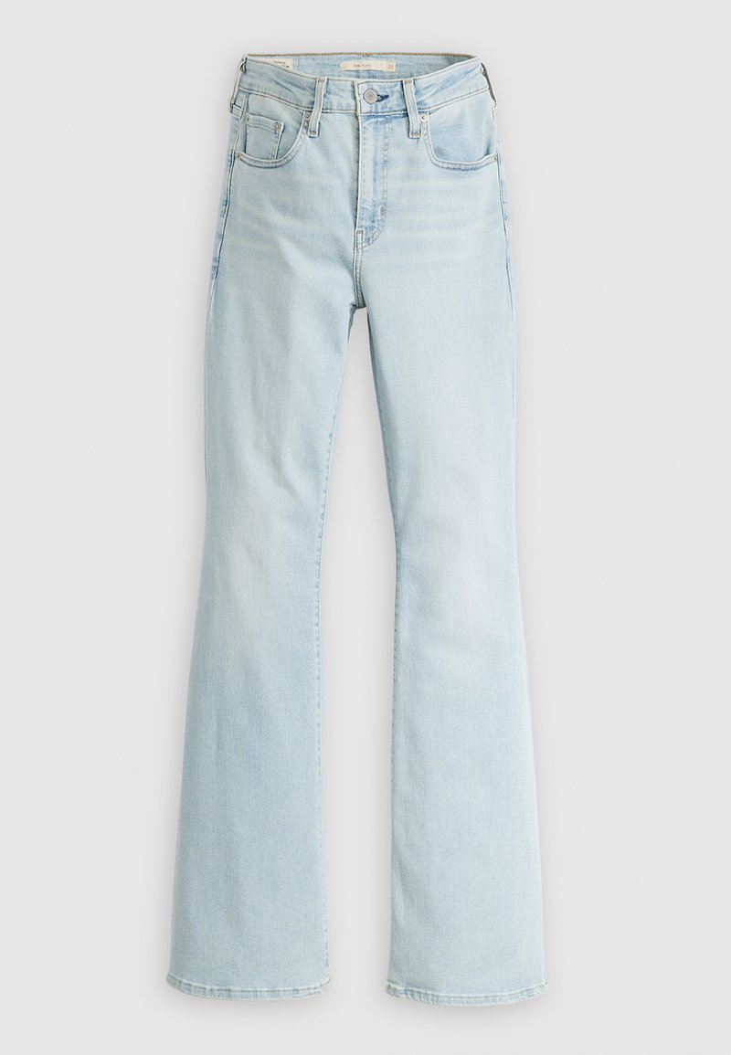 Vaqueros acampanados de color azul claro con cintura alta, diseño de cinco bolsillos y un leve deslavado. Hechos de denim con una textura suave y detalles de costura.