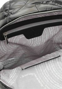 Interno di una borsa a tracolla nera imbottita con una fodera grigia con zip caratterizzata da vari modelli di testo e una tasca. La ferramenta comprende un tirante per la zip.