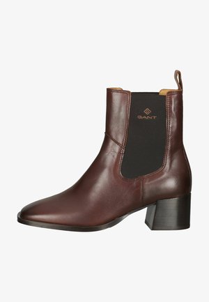 Brown leather ankle boot with elastic side panels, pointed toe, and a low block heel. Features embossed logo on the outer side.