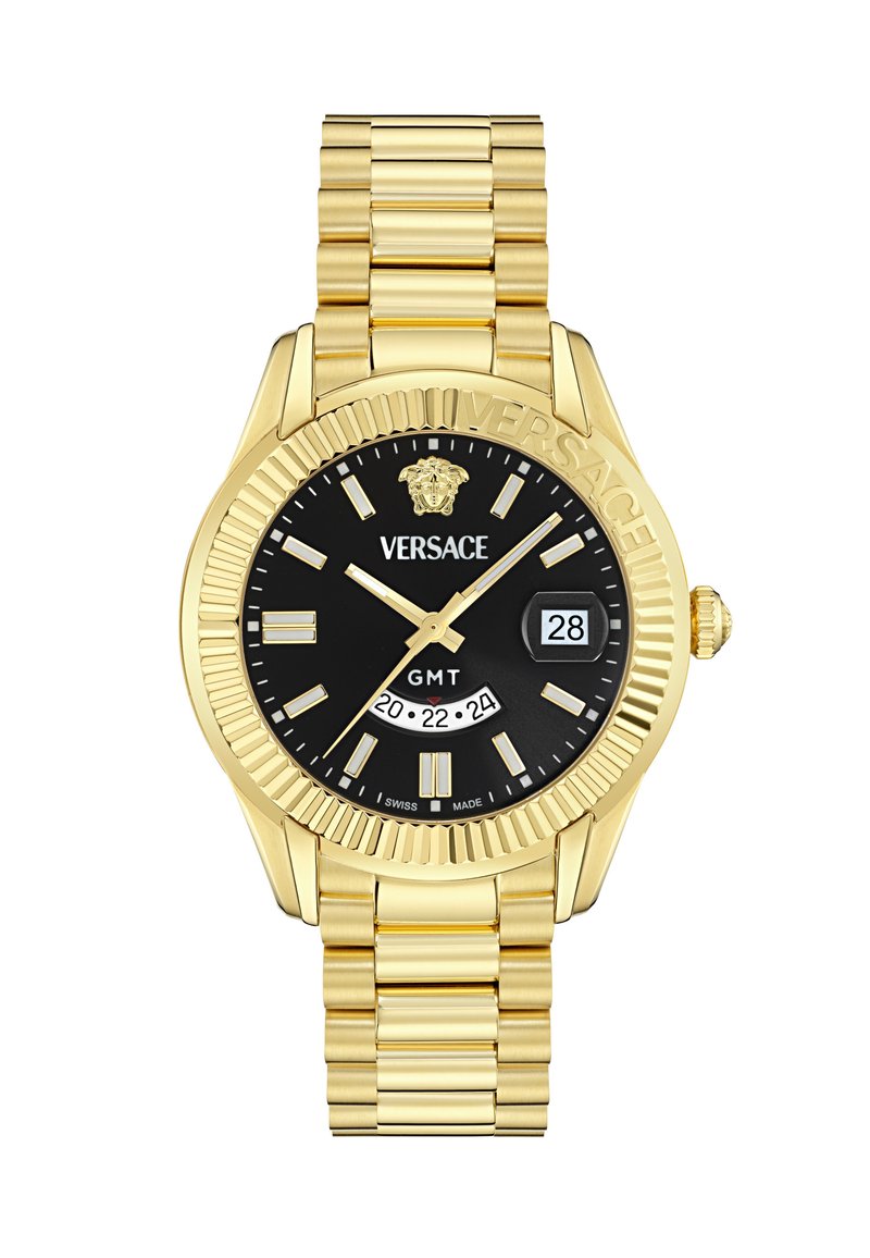 Zelta toņa metāla pulkstenis ar melnu ciparnīcu, kas piedāvā GMT displeju, datuma logu un luminescējošus stundu atzīmējumus. Dekoratīvs rāmītis un saistīts rokassprādze.