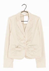Béžové sako s členitými klopami a dvěma předními kapsami. Má jednorehé knoflíky a nashromážděné detaily na kapsách. Bavlněná směsová látka.