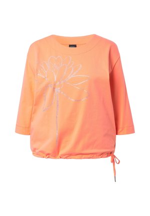 Korally-orange langærmet top med stort sølvfarvet rhinstenblomsterdesign foran og justerbar snøre i kanten på højre side.