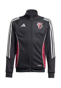 Melnā zipa jakā ar baltiem un sarkaniem svītrainiem, izgatavota no gludas auduma. Iekļauta adidas zīme un dizaina elements augšējā kreisajā pusē.