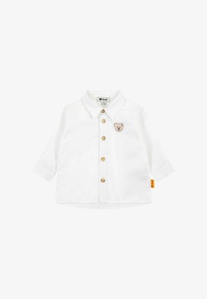 Chemise blanche à manches longues pour bébé avec col, cinq boutons sur le devant, et petite écusson ours en peluche sur la poitrine gauche.