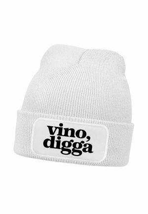 White knit beanie with ribbed texture, featuring a black graphic label that reads "vino, digga" on a rectangular patch.