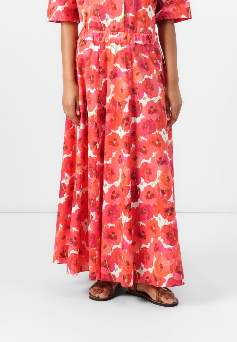 Maxikleid mit floralem Muster in Rot- und Rosa-Tönen. Hergestellt aus leichtem Stoff, mit kurzen Ärmeln, elastischem Bund und fließender Silhouette.