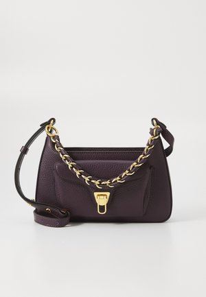 Purple leather handbag with a textured finish, gold chain handle, and a magnetic clasp. Features a front pocket and adjustable strap.