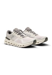Lightweight running shoes in white and gray. Mesh upper with synthetic accents, cushioned sole with distinct circular cutouts.