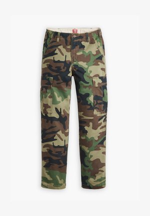 Cargo pants in a camouflage pattern featuring green, brown, and black tones. Made from cotton with multiple pockets and a relaxed fit.