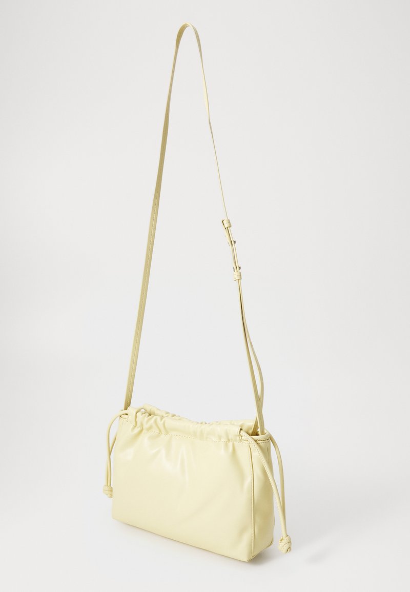 Calvin Klein Jeans DRAWSTRING BAG - Taška s příčným popruhem - parsnip