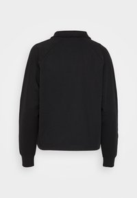 Svart sweatshirt med krage, raglanärmar, ribbade ärmslut och sömlös design. Mjuk textur och avslappnad passform.