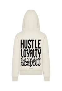 Cream-colored hoodie with a large black print on the back: "HUSTLE LOYALTY RESPECT" in varied bold fonts. Features a kangaroo pocket and hood.