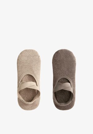 Two pairs of ankle socks, one beige and one brown, with elastic cross-straps and a soft, textured fabric finish.