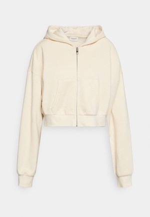 Roomkleurige cropped hoodie met volledige ritssluiting aan de voorkant, voorvak, lange mouwen en capuchon.
