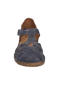 Navy leather sandal with cross-strap design, open sides, and a textured sole. Features adjustable strap and contrasting stitching details.