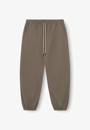 Lichtbruine joggers met een elastische tailleband, verstelbare trekkoord, zijzakken en taps toelopende boorden. Gladde stof met subtiele merkdetails.