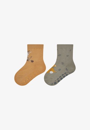 Pair of toddler socks: one orange with giraffe print, the other olive green with animal accents. Both feature textured grips on the soles.