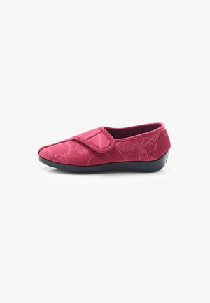 Red textile slipper with floral design, hook-and-loop strap, rounded toe, and black rubber sole for durability and comfort.