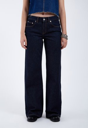 Wide-leg dark blue denim jeans with a classic five-pocket design, light stitching, and a slightly frayed hem at the cropped top.