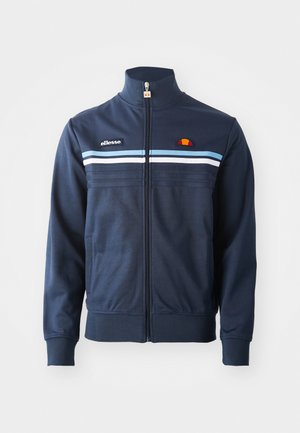 Navy blue zipped jacket with light blue and white horizontal stripes, high collar, and ellesse logo patches on chest and zipper pull.