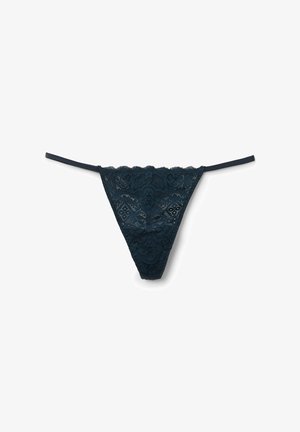 String en dentelle de couleur teal foncé avec des bords festonnés, des bretelles étroites et des détails à motif floral, mettant en valeur une texture semi-transparente et une finition lisse.