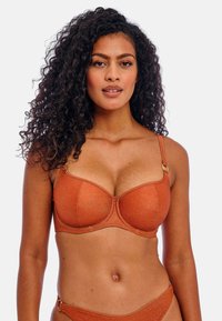 Underwire bra in rusty orange fabric with a textured finish, featuring adjustable straps and gold-tone hardware accents.