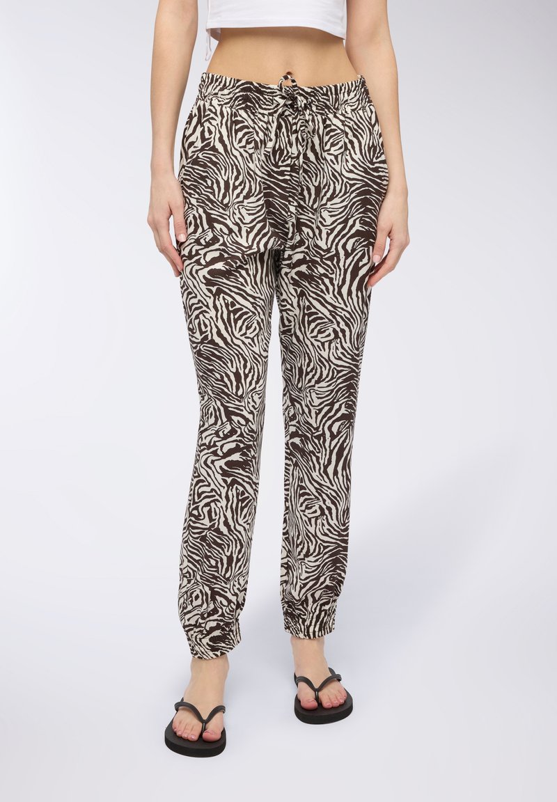 Joggers a righe zebra marrone e crema con vita elastica, tasche laterali e caviglie elastiche, realizzati in un tessuto leggero.