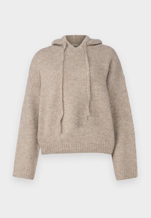 Felpa beige lavorata a maglia con vestibilità morbida, maniche lunghe e cordino al collo. Tessuto testurizzato e dettaglio a coste sull'orlo.