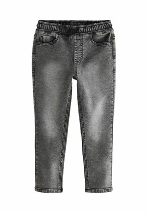 Jean noir et gris délavé à taille élastique avec poches avant, l'une contenant un petit portefeuille ou un téléphone, sur fond blanc.