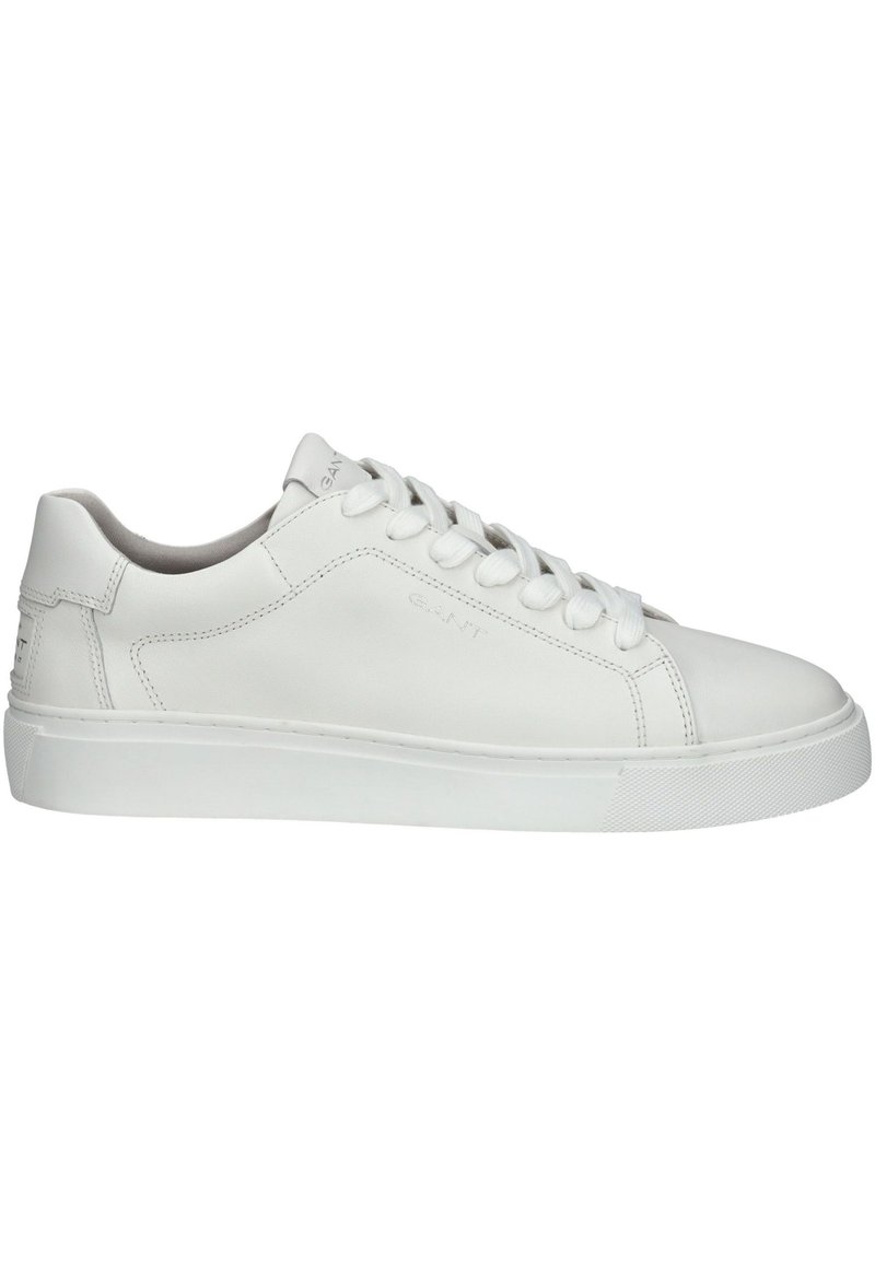 Vit lädersneaker med slät yta, rund tå och platt gummisula. Har sex öglor och diskret branding på sidan.