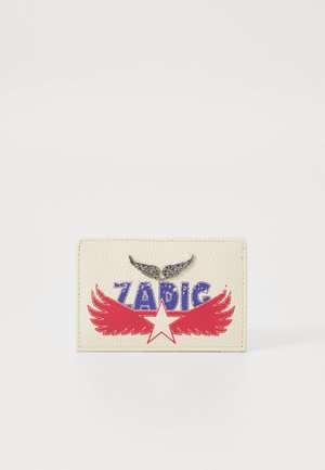 Cream leather cardholder featuring blue "ZADIG" text, red wings and star design, with silver wing-shaped accents on top.