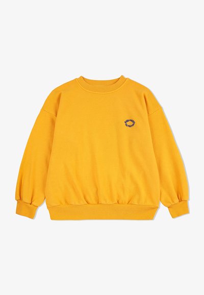 Sweatshirt jaune à col rond et coupe surdimensionnée. Caractéristiques : poignets et ourlet côtelés, et un petit logo brodé bleu sur la poitrine.