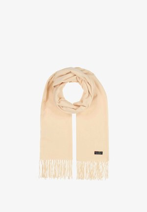 Écharpe beige en tissu doux, présentant des franges aux extrémités et une texture subtile, avec une étiquette de marque attachée sur un côté.