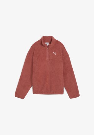 Pull en polaire couleur rouille avec manches longues, fermeture éclair quart de zip à l'avant, col montant et logo Puma blanc sur le côté gauche de la poitrine.