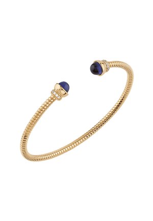Goudkleurige armband met een flexibele, opgerolde vorm, voorzien van twee blauwe stenen en diamantaccenten aan elk uiteinde.