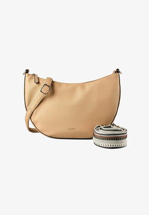 Sac à bandoulière en cuir beige avec sangle ajustable, bordure noire et sangle supplémentaire en tissu enroulé avec des motifs marron, noir et blanc.