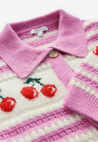 Gebreide trui met een roze kraag, voorzien van horizontale strepen in lichtroze en wit. Rode kersenborduursel en een knopdetail.