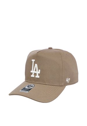 Tan adjustable baseball cap with white embroidered "LA" logo on front and "47" logo on side, curved brim and fabric button on top.