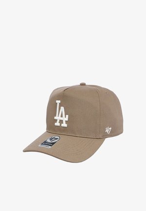 Tan adjustable baseball cap with white embroidered "LA" logo on front and "47" logo on side, curved brim and fabric button on top.