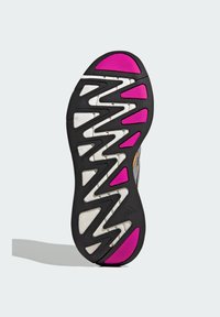 Black shoe sole featuring zigzag tread pattern, with pink accents on the heel and midsole. Material appears textured and rubberized.