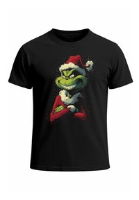 Black t-shirt with a graphic of a green mischievous character wearing a red Santa hat and red coat with white trim, arms crossed.