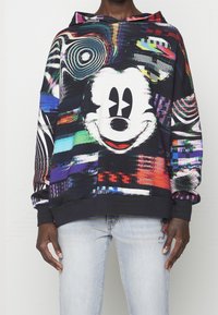 Färgglad hoodtröja med ett stort Mickey Mouse-motiv. Har livliga abstrakta mönster, en justerbar huva och ribbade muddar och nederkant.