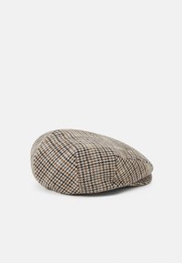 Checkered flat cap made of wool, features a brown, beige, and black pattern, featuring a rounded top and a small brim.