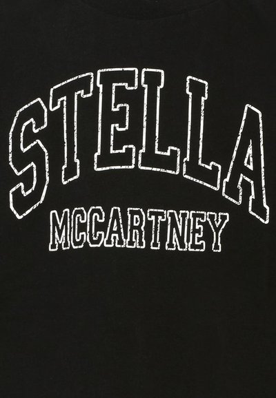 T-shirt noir avec un texte blanc en gras qui indique "STELLA McCARTNEY". Le texte a un aspect usé et un design en arc.